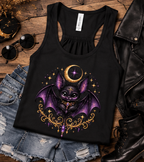 Black Vespertine Moonwatcher racerback tank featuring a purple celestial bat and gold crescent moon design, styled in a flat lay with denim shorts, sunglasses, leather jacket, and black boots.