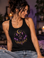 Female model wearing a black Vespertine Moonwatcher racerback tank featuring a purple celestial bat, crescent moon, stars, and ornate gold accents in a moody gothic setting.