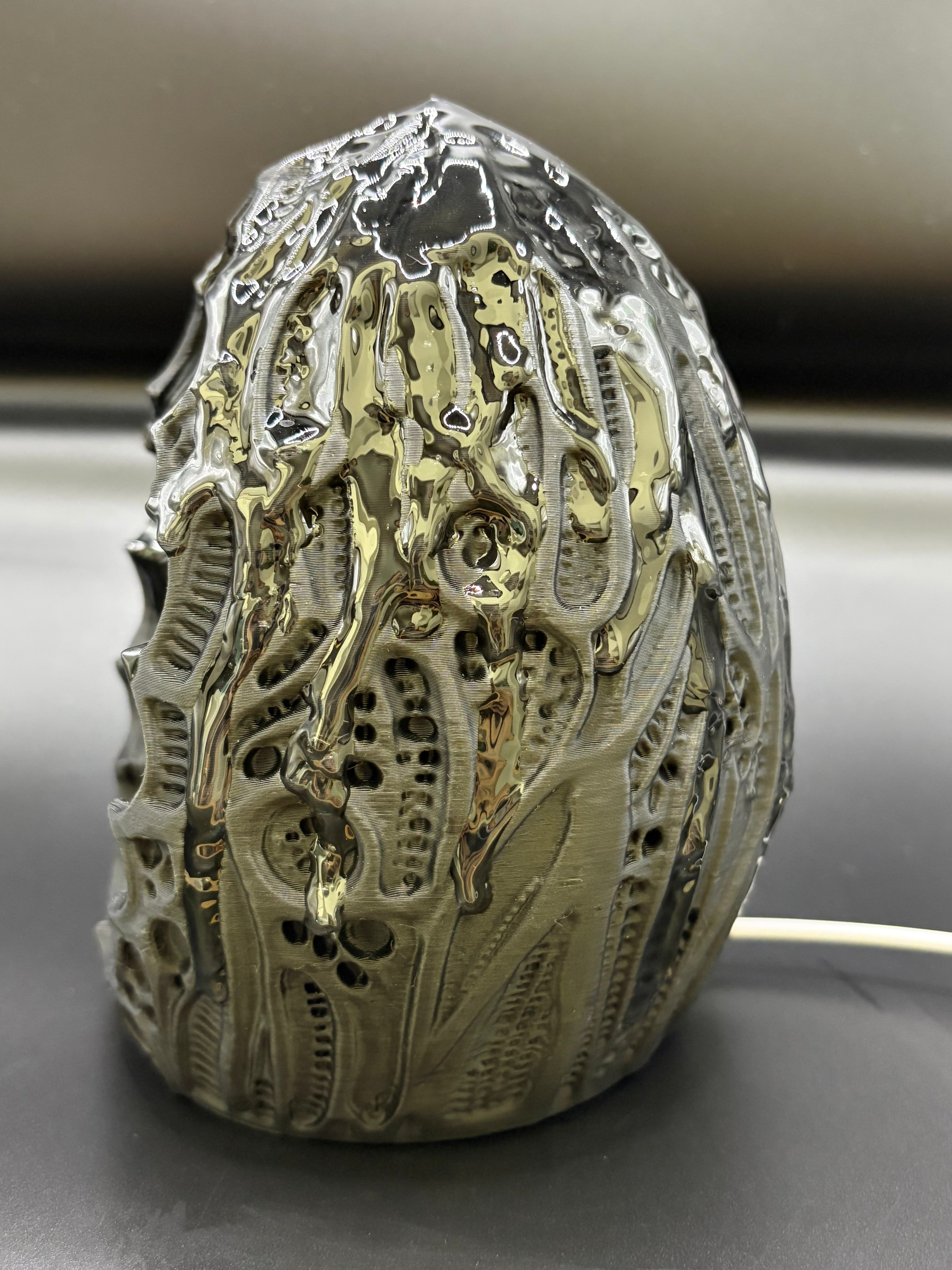 Left side angled view of the Shardlurker Specimen Night Light showing the glossy resin-finished containment egg and push-button power cable