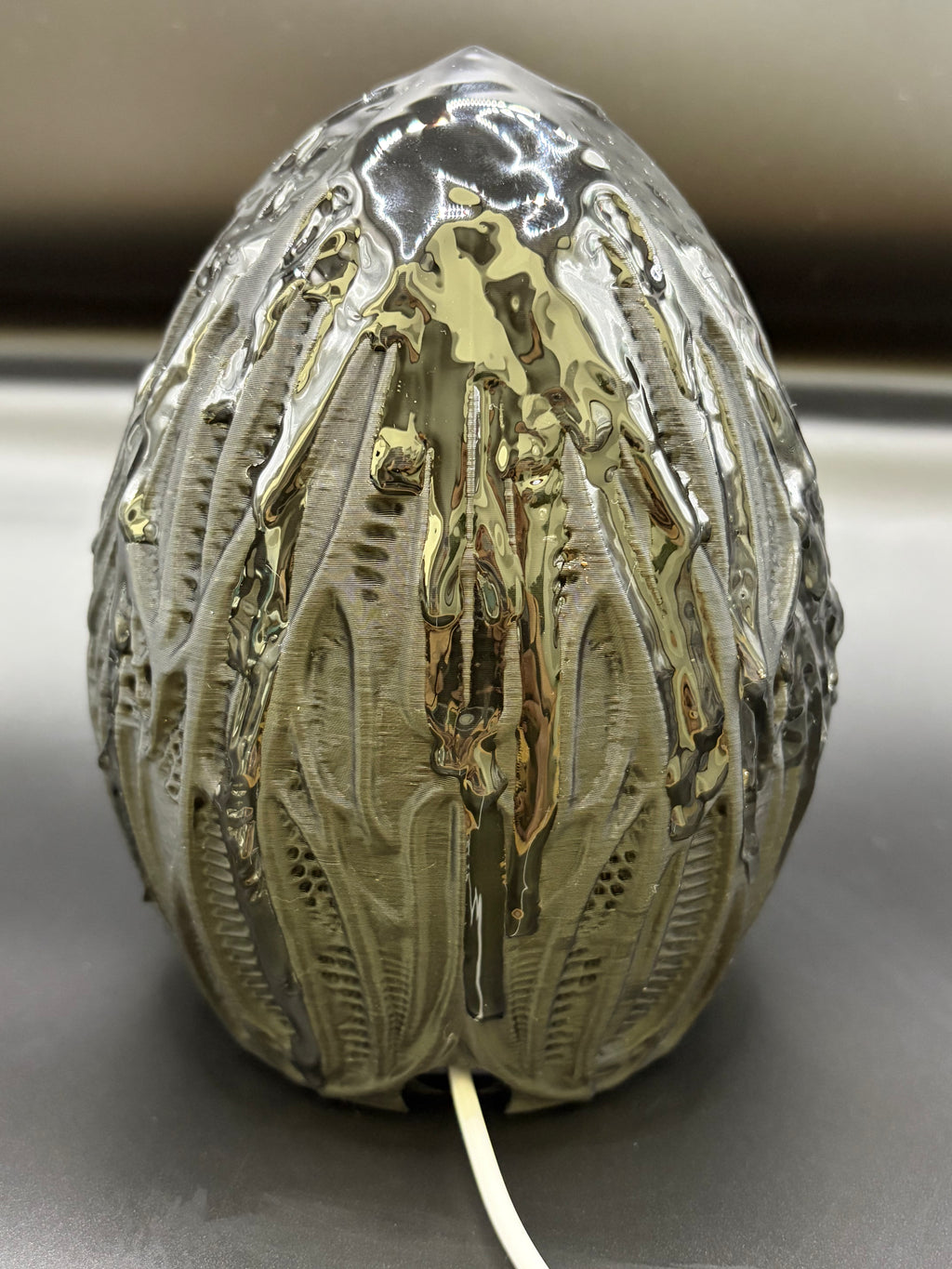Rear view of Shardlurker Specimen Night Light showing glossy resin-finished containment egg and power cable