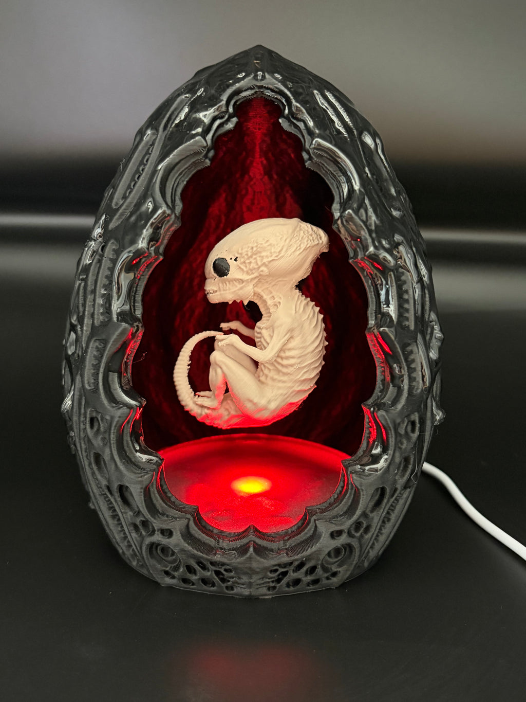 Shardlurker Specimen Night Light with glossy resin-finished containment egg illuminated in red