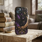 Vespertine Gothic Moon Bat phone case displayed beside vintage books, featuring a black bat, crescent moon, purple crystals, stars, and ornate gold details