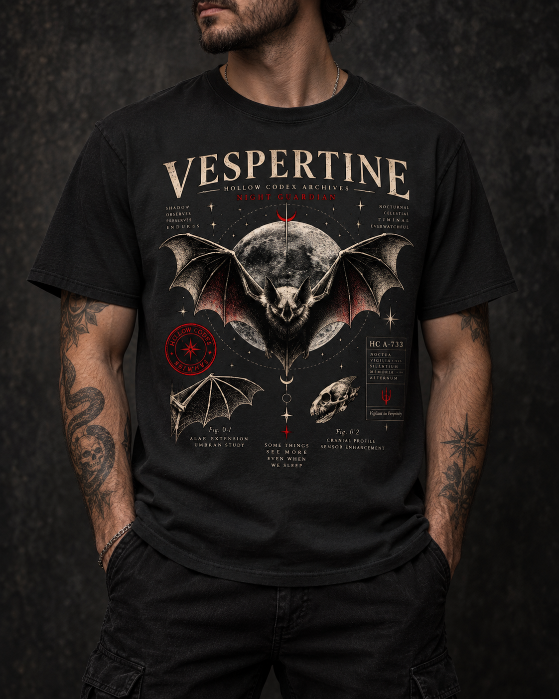 Model wearing a black Vespertine Night Guardian graphic T-shirt featuring a celestial bat, full moon, anatomical details, and red accents.